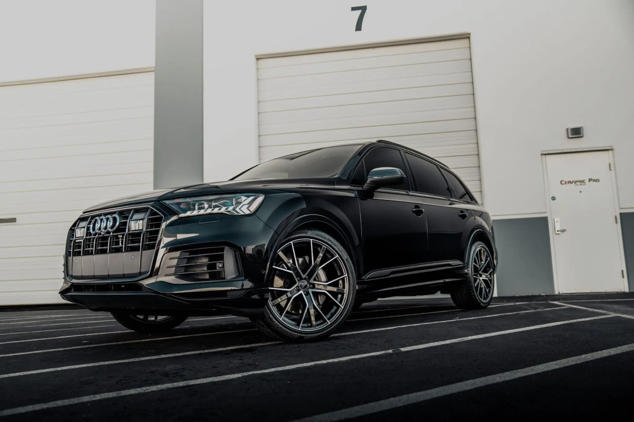 Black Audi SUV parked near garage doors.