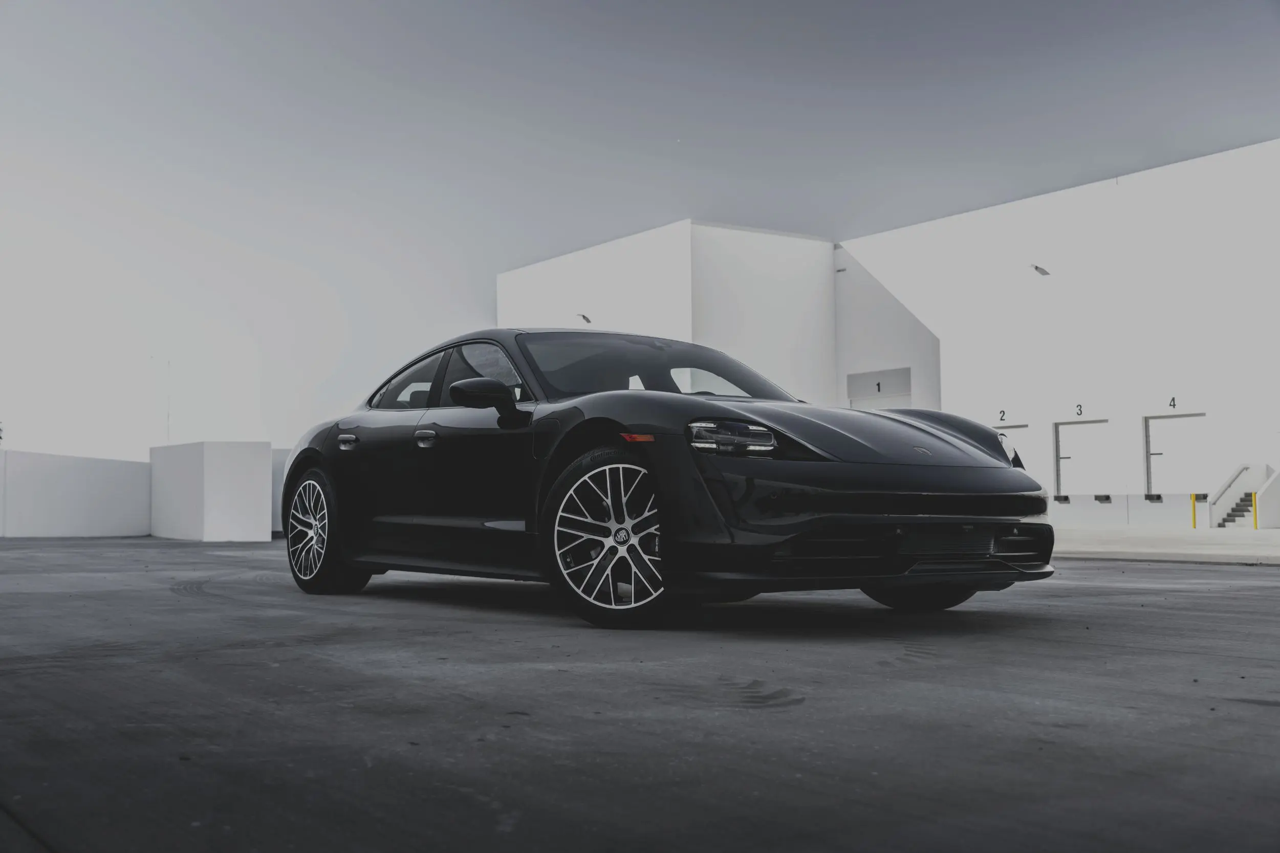 Black sports car in urban setting.