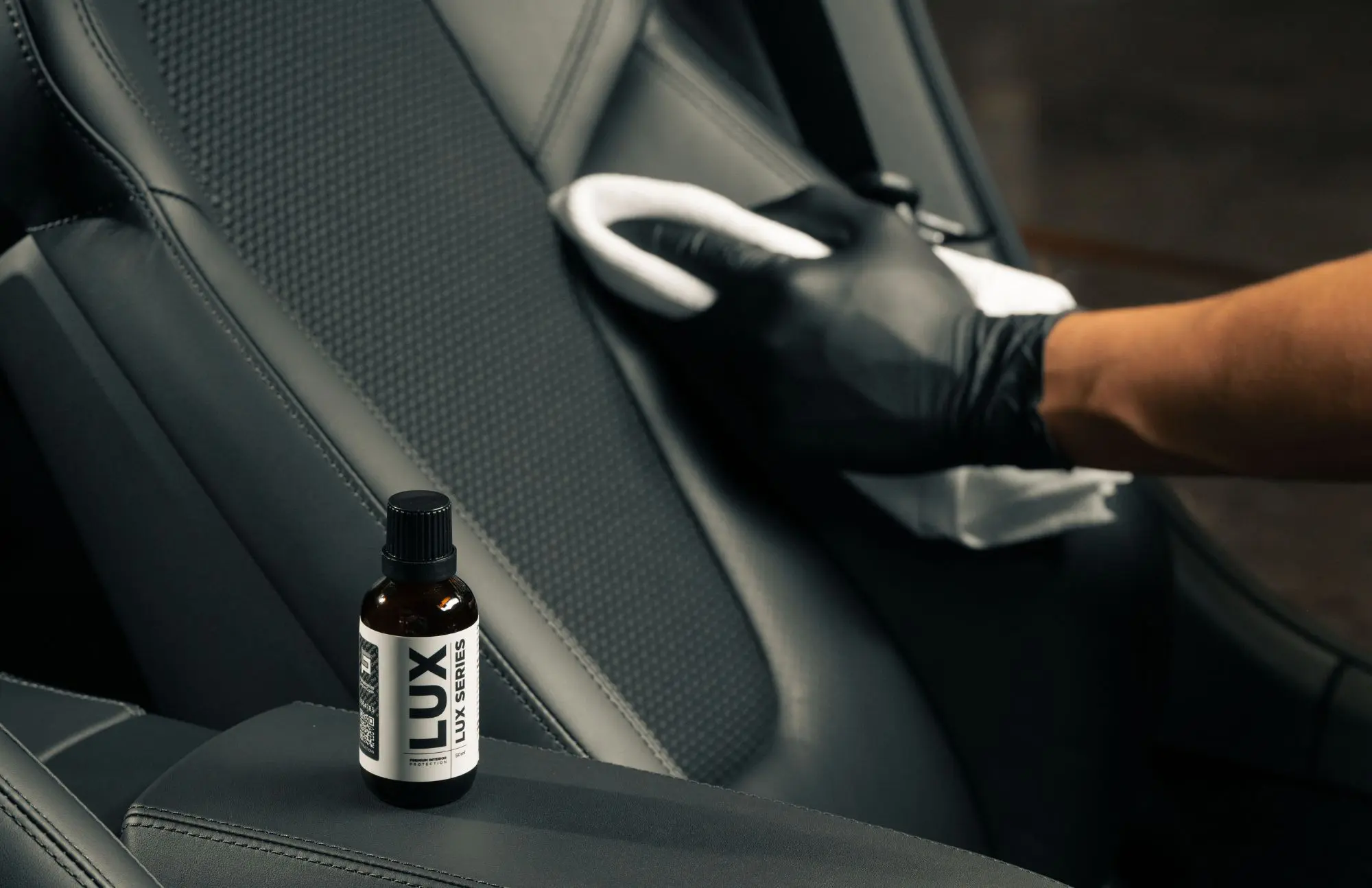 Cleaning car seat with leather care product.
