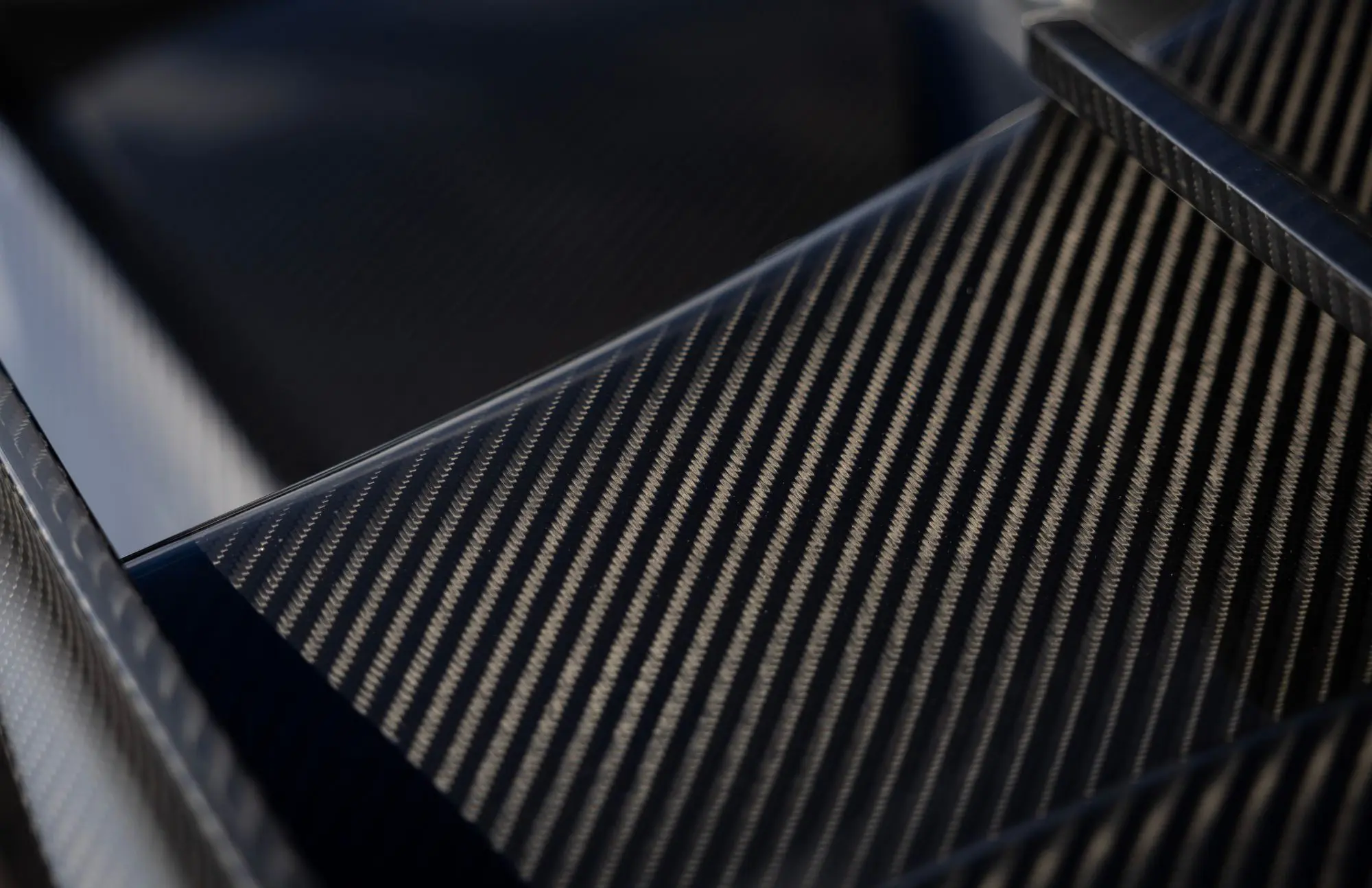 Close-up of textured carbon fiber surface.