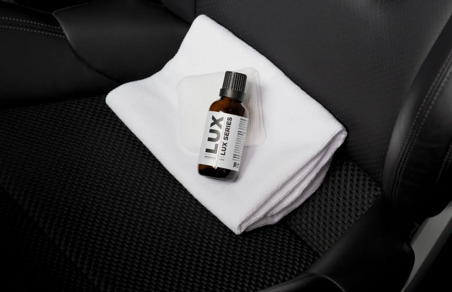 Bottle on cloth on car seat.