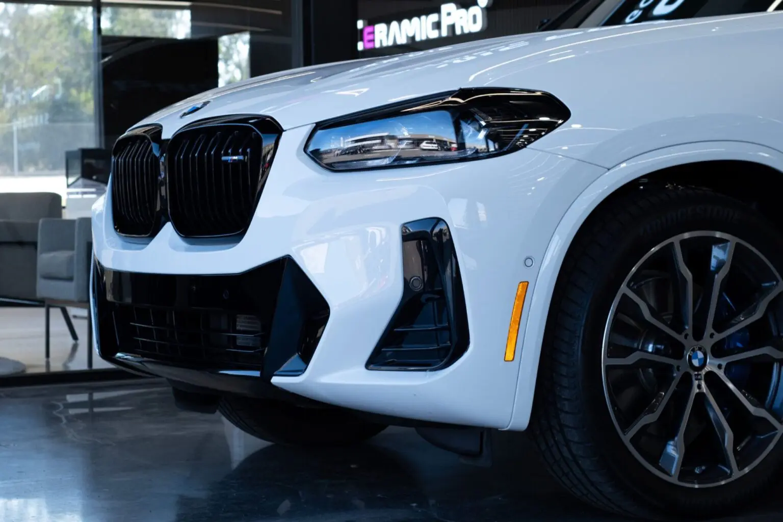 Close-up of white luxury car front view.