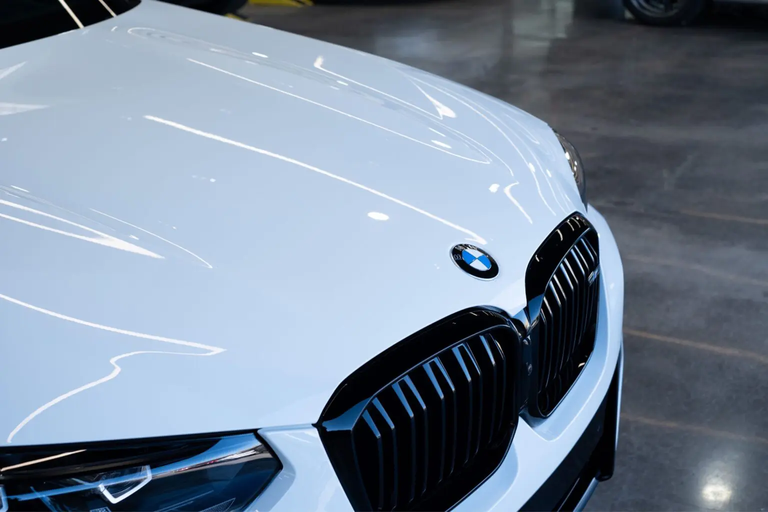 White BMW car front with shiny grille.