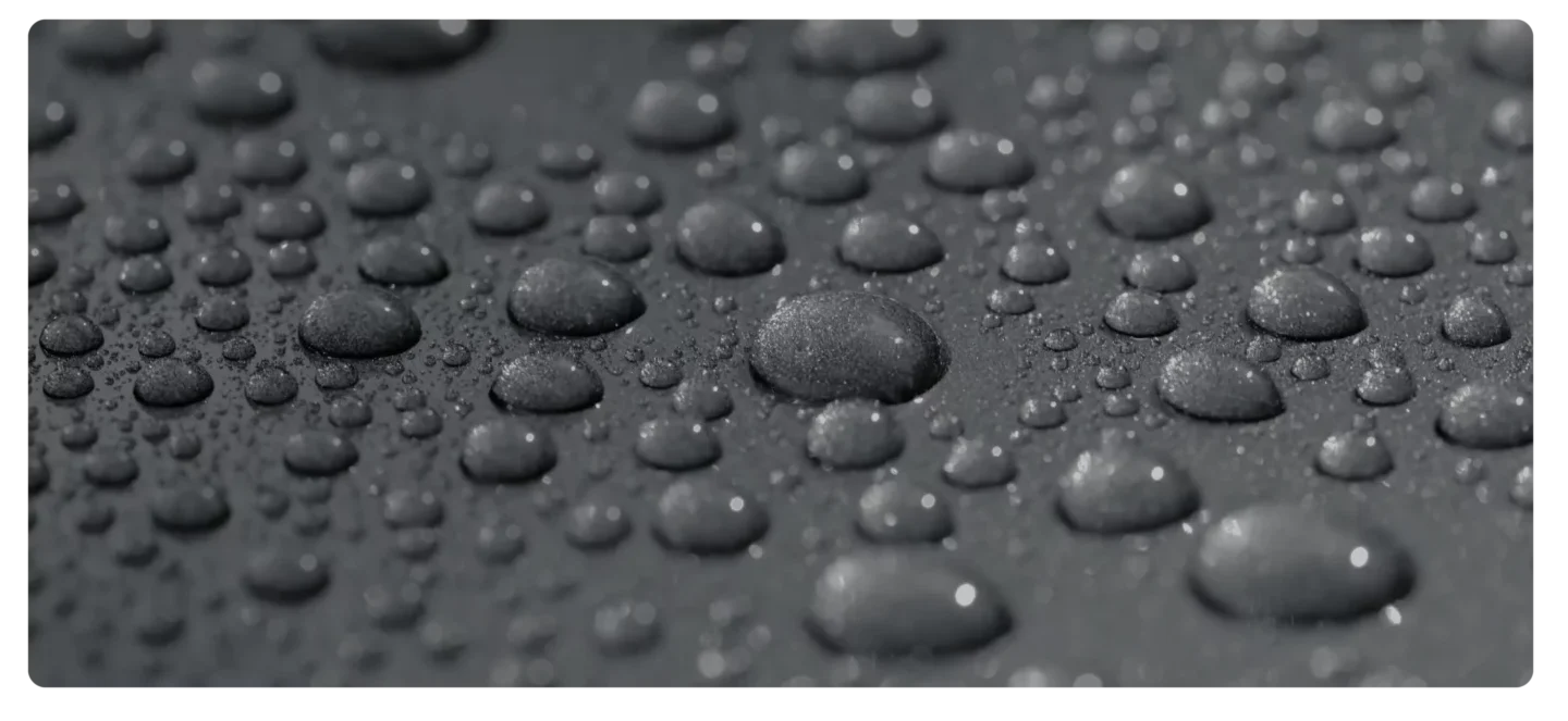 Water droplets on a dark surface.