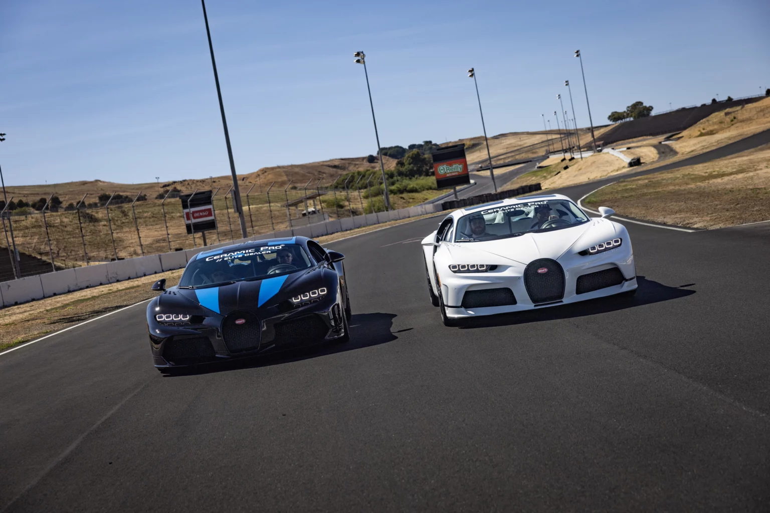 Two sports cars driving on a track.