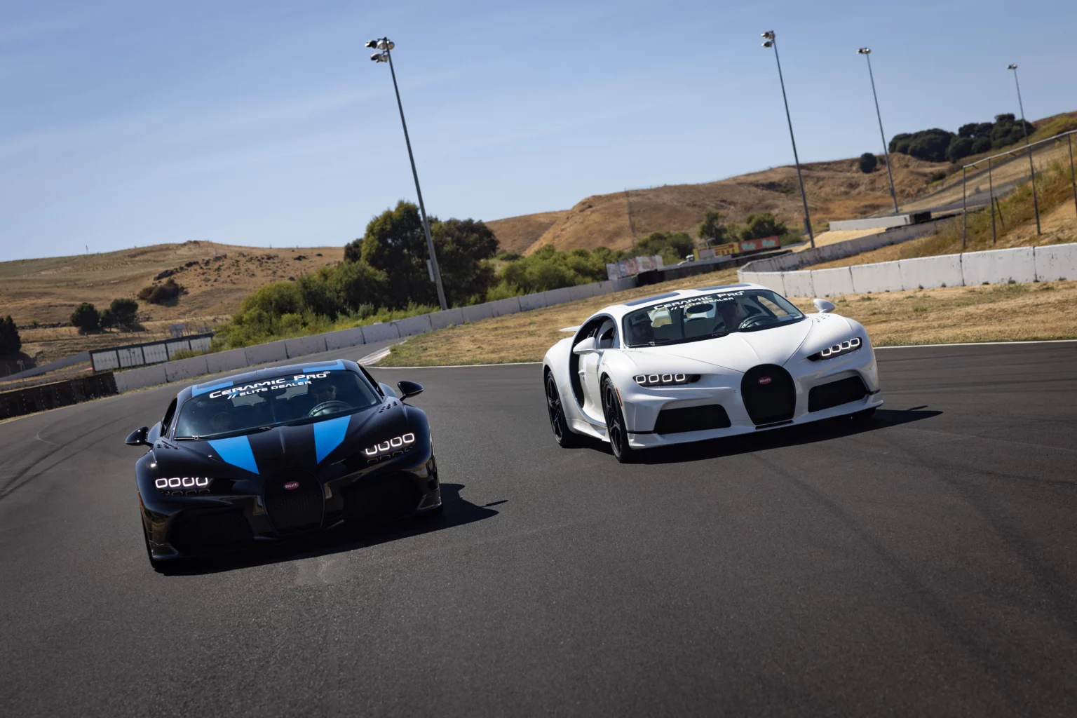Two luxury sports cars on racetrack.