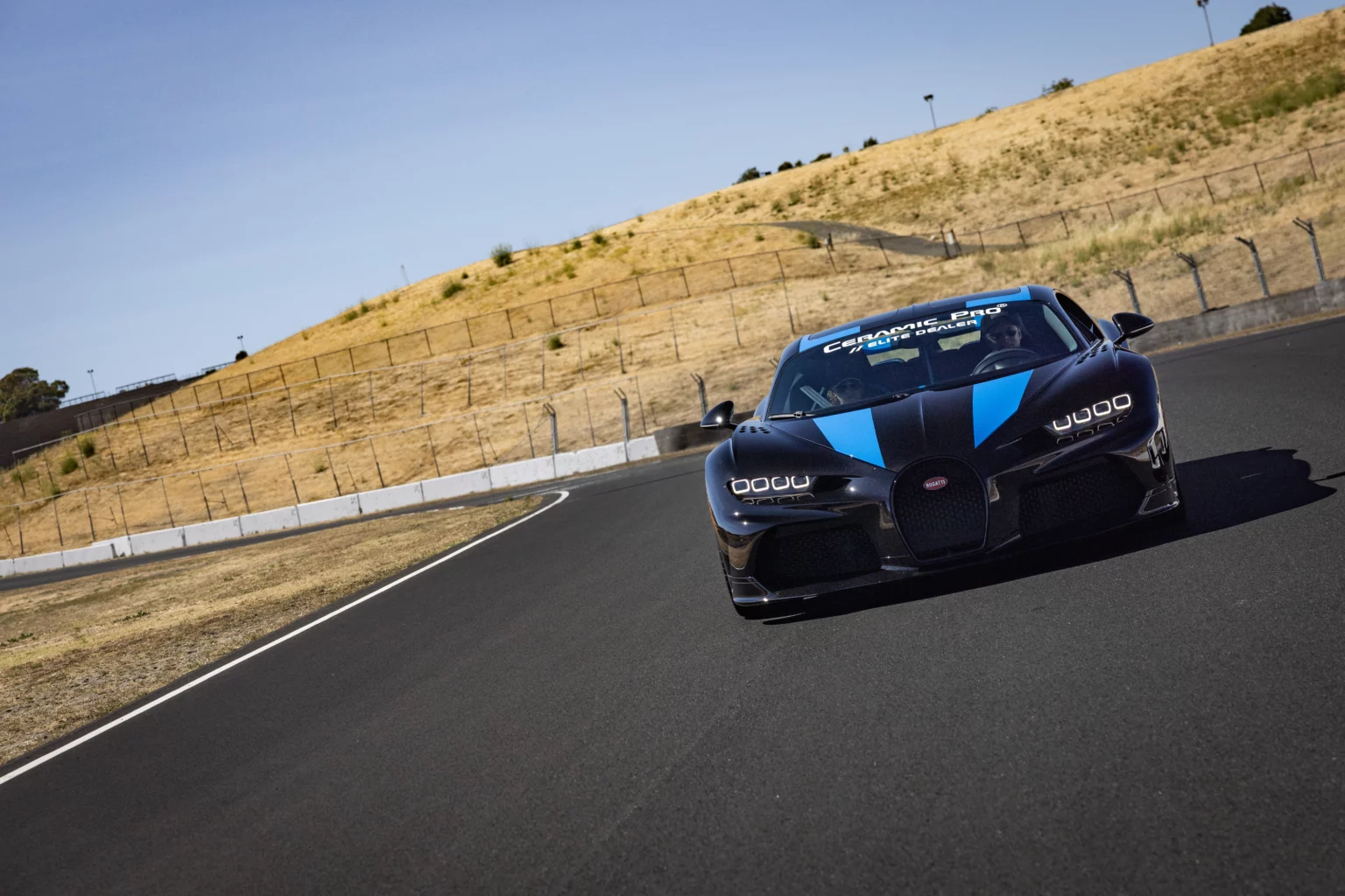 Blue sports car on a racetrack.