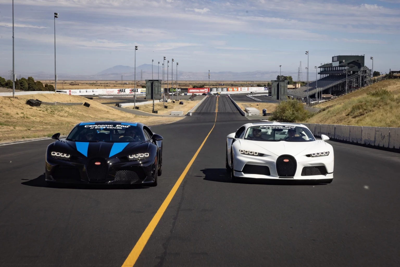 Two sports cars on an empty racetrack.
