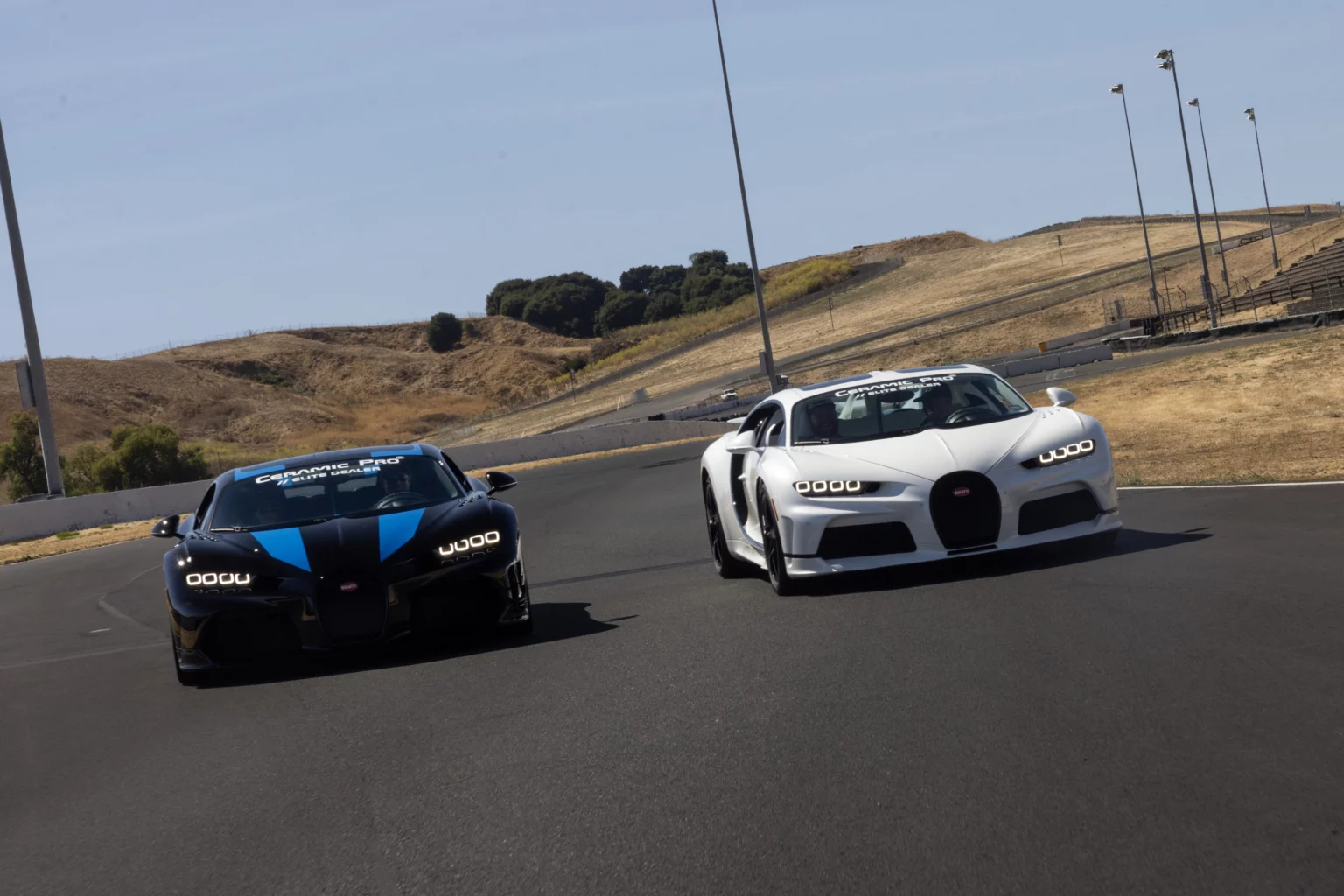 Two luxury sports cars on racetrack.