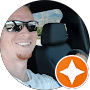 A man in the back of a car with an orange star.