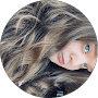 A woman with long hair and blue eyes.